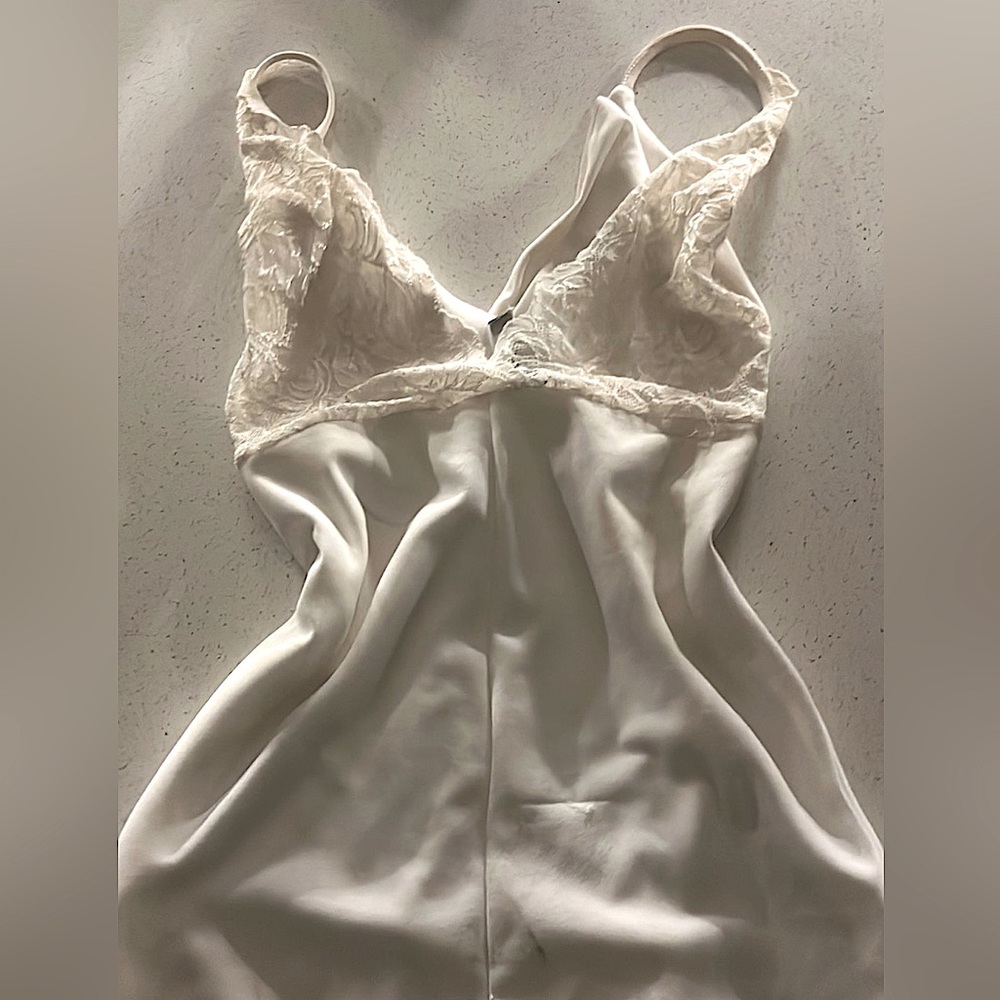 A white dress with a lace back and stops about mid thigh or higher. Will try on
